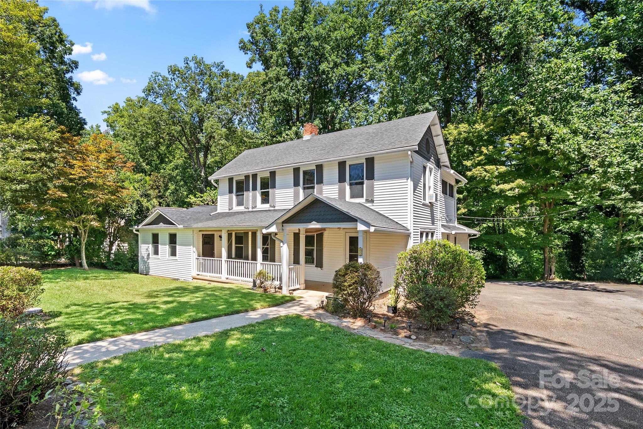 80 Laurel Avenue Tryon, NC 28782 - Photo 2 of 43 a front view of a house with a yard and trees