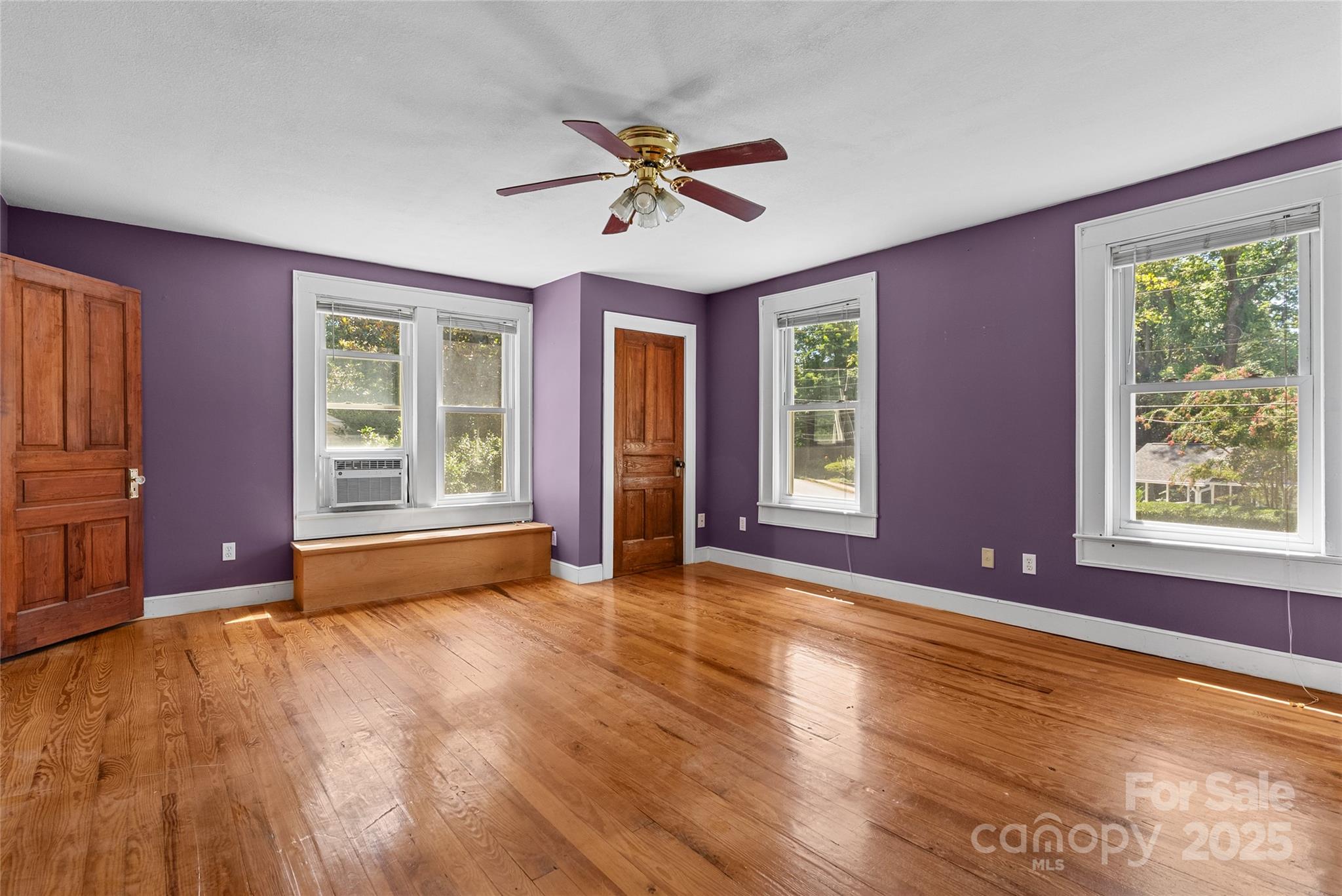 80 Laurel Avenue Tryon, NC 28782 - Photo 22 of 43 a view of an empty room with a window and wooden floor