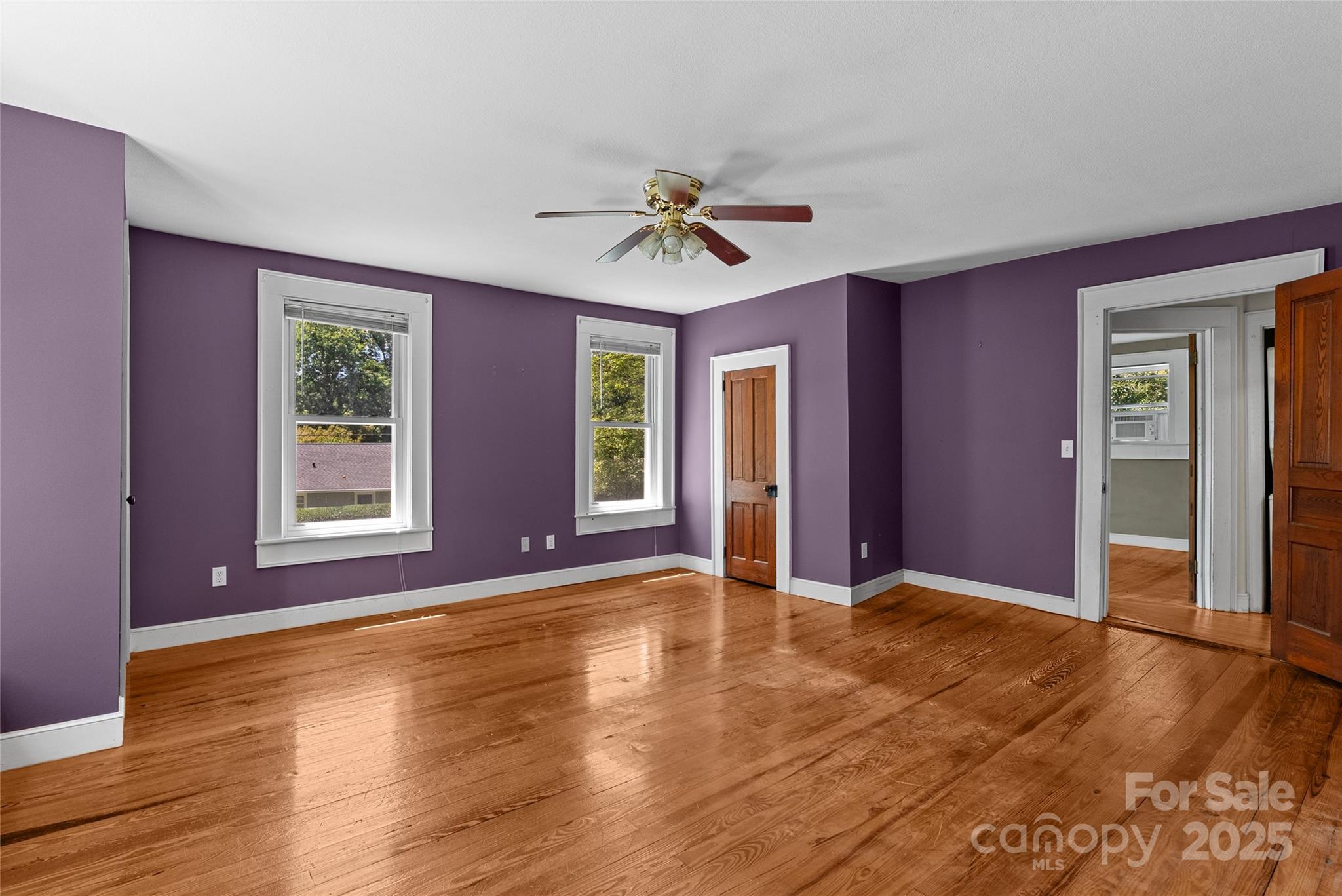 80 Laurel Avenue Tryon, NC 28782 - Photo 23 of 43 a view of livingroom with window ceiling fan and hardwood floor