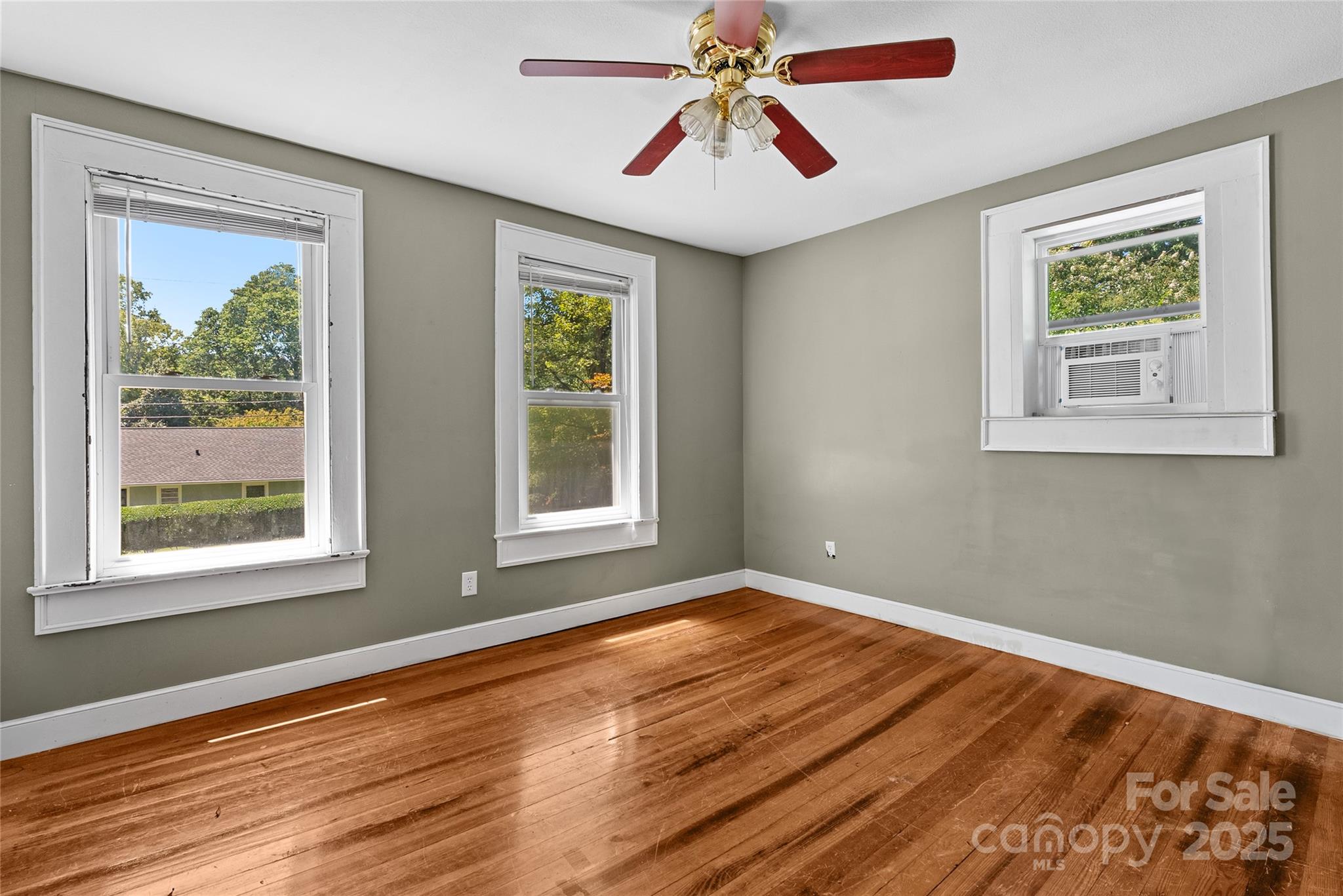 80 Laurel Avenue Tryon, NC 28782 - Photo 25 of 43 a view of empty room with wooden floor and fan