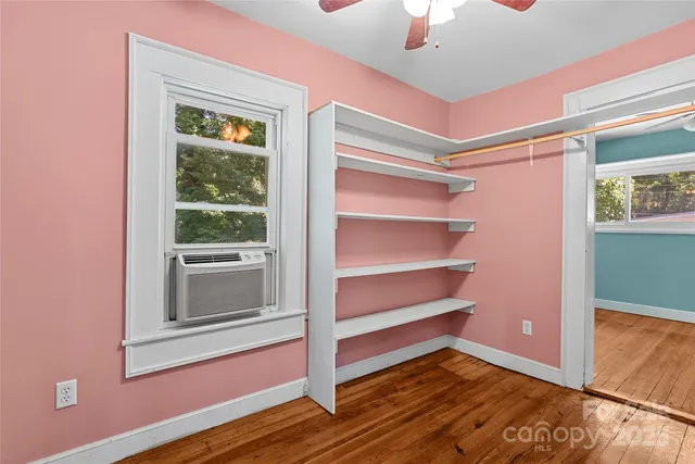 a view of room with window and wooden floor