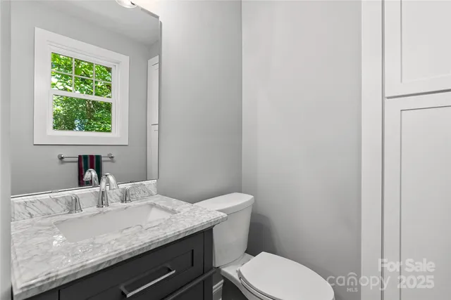 a spacious bedroom with a bed a couch and potted plant with the outer view