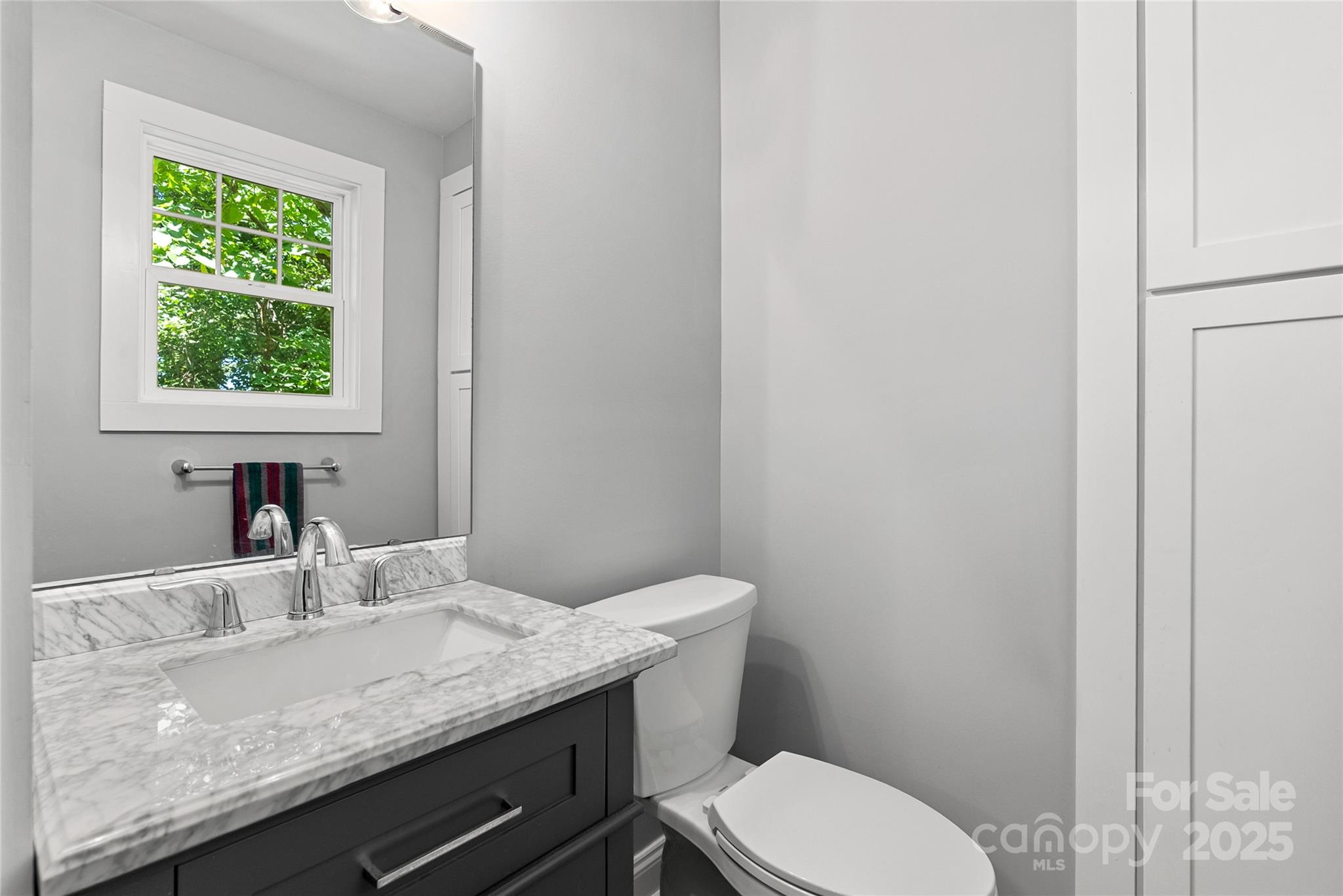 80 Laurel Avenue Tryon, NC 28782 - Photo 33 of 43 a bathroom with a granite countertop toilet sink and mirror