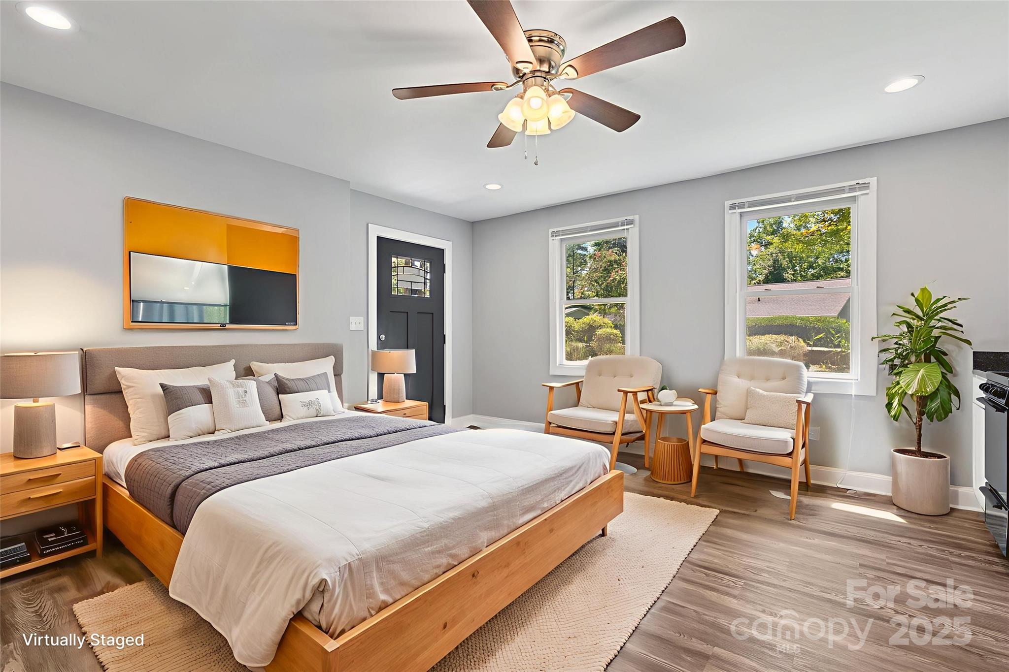 80 Laurel Avenue Tryon, NC 28782 - Photo 34 of 43 a spacious bedroom with a bed a couch and potted plant with the outer view