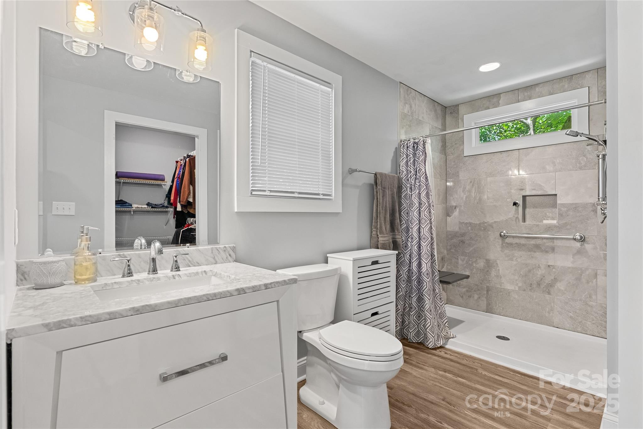 80 Laurel Avenue Tryon, NC 28782 - Photo 38 of 43 a bathroom with a sink a toilet and shower