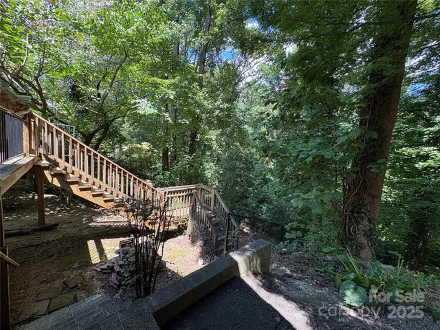 a balcony with wooden floor and trees