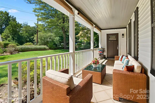 a view of a porch with furniture and garden