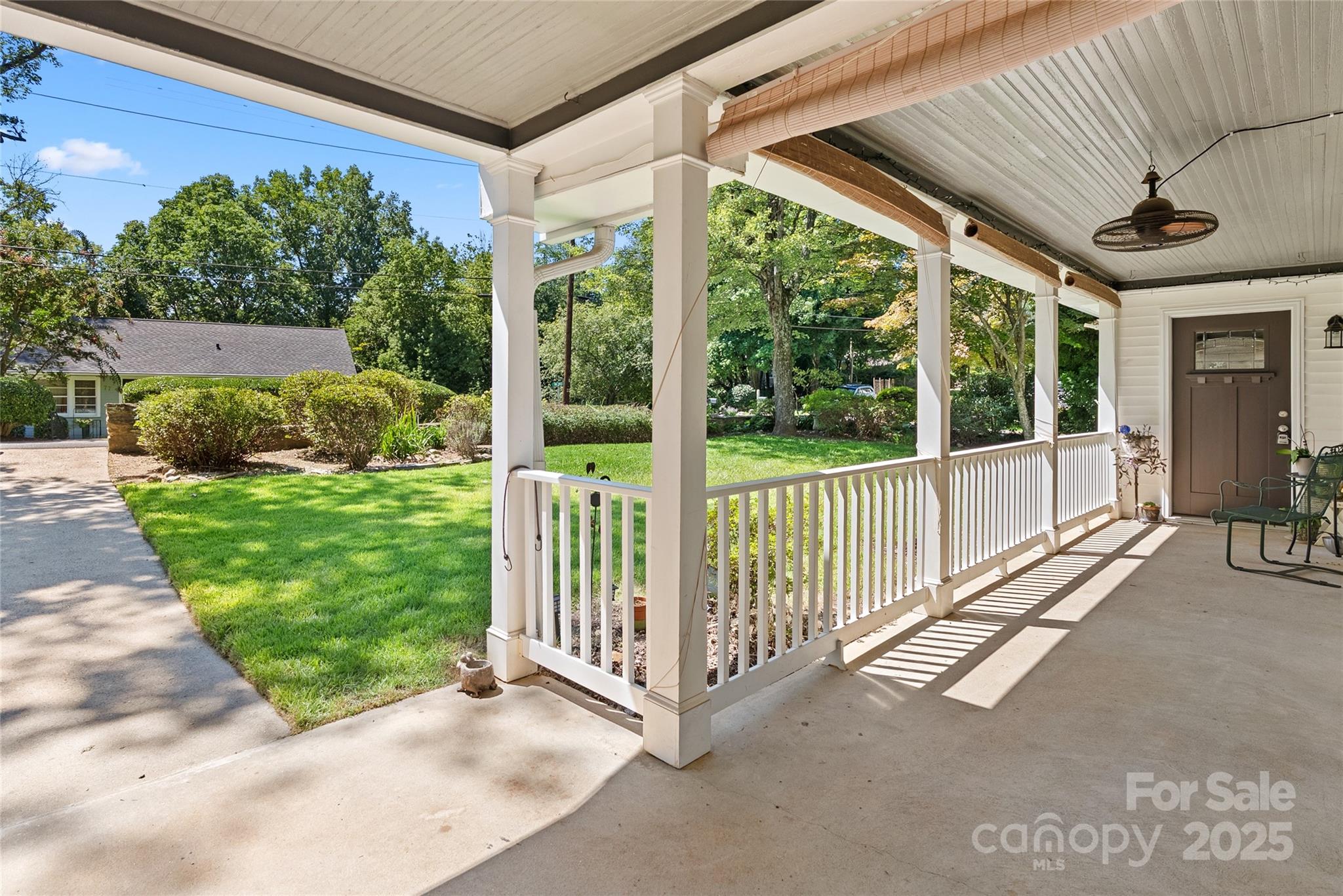 80 Laurel Avenue Tryon, NC 28782 - Photo 6 of 43 a view of a porch with furniture and garden