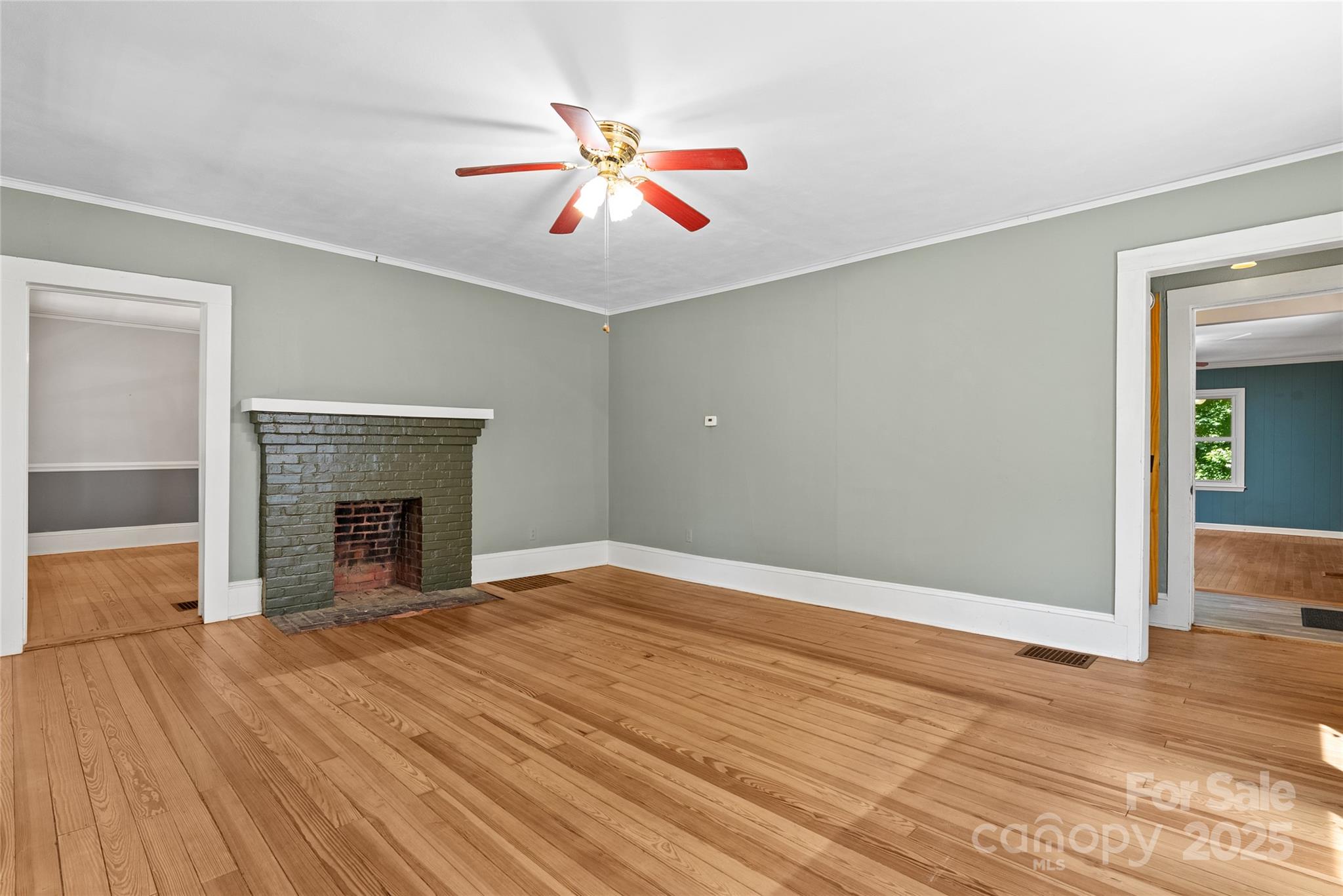 80 Laurel Avenue Tryon, NC 28782 - Photo 9 of 43 a view of empty room with wooden floor and fireplace