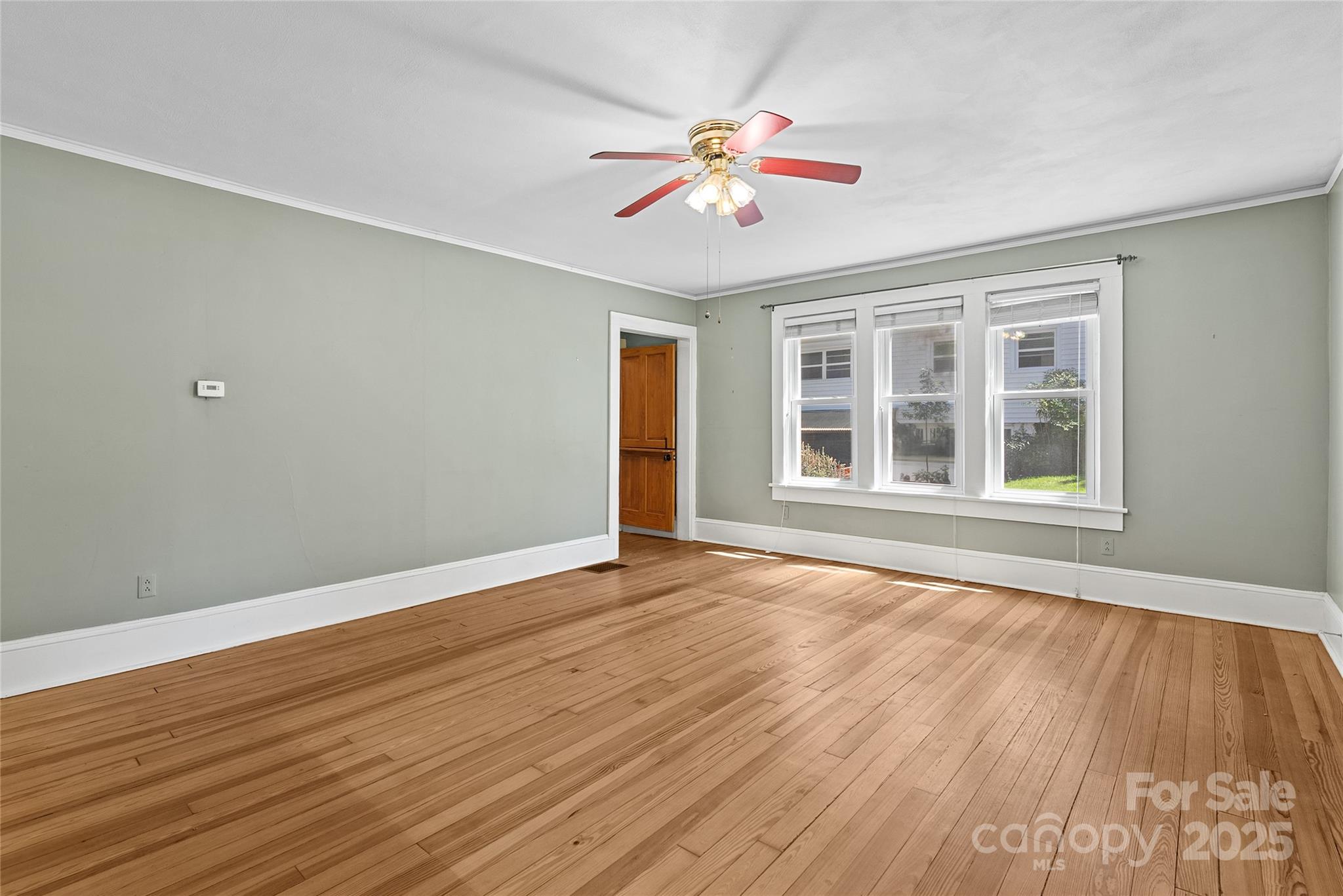 80 Laurel Avenue Tryon, NC 28782 - Photo 10 of 43 a view of an empty room with wooden floor and a window