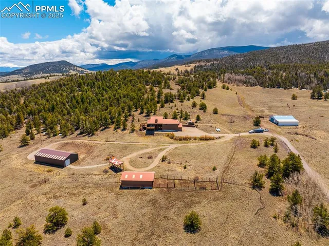 a view of a large building with mountains in the background