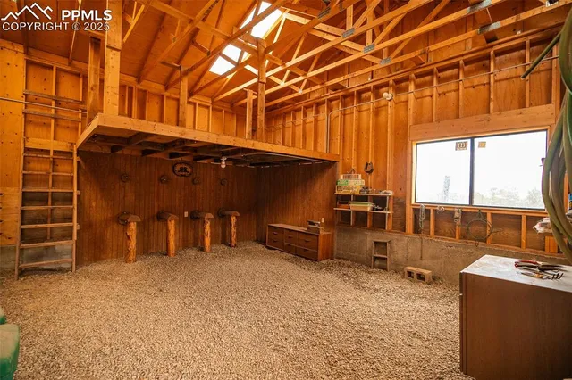 a view of a room with furniture and a window