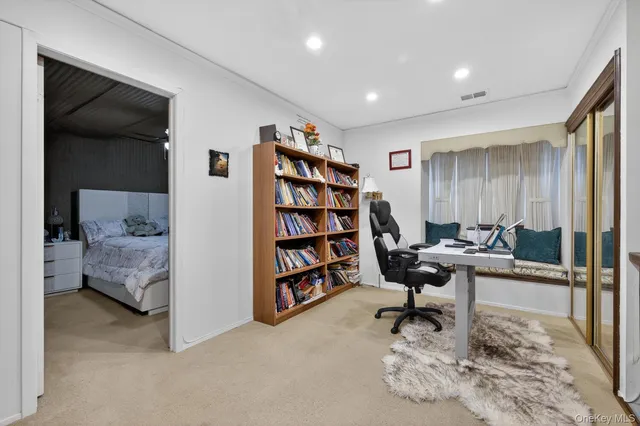 a bedroom with a bed and a large window