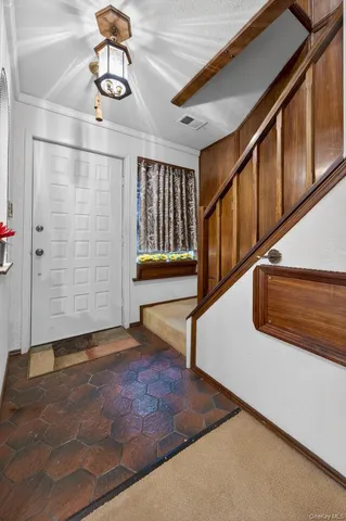 a spacious bedroom with a bed couch and a window