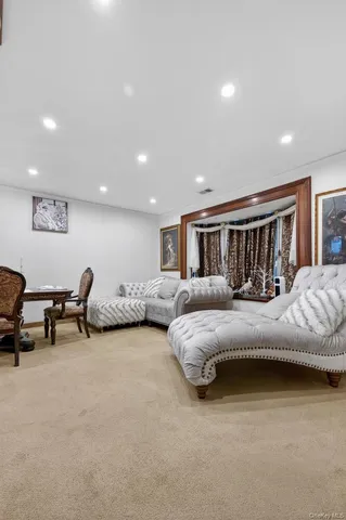 a view of a dining room with furniture and chandelier