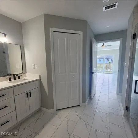 a bathroom with a double vanity sink and mirror