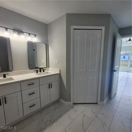 a spacious bathroom with a double vanity sink and a mirror