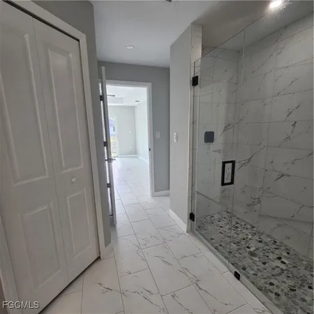 a bathroom with a shower and a sink