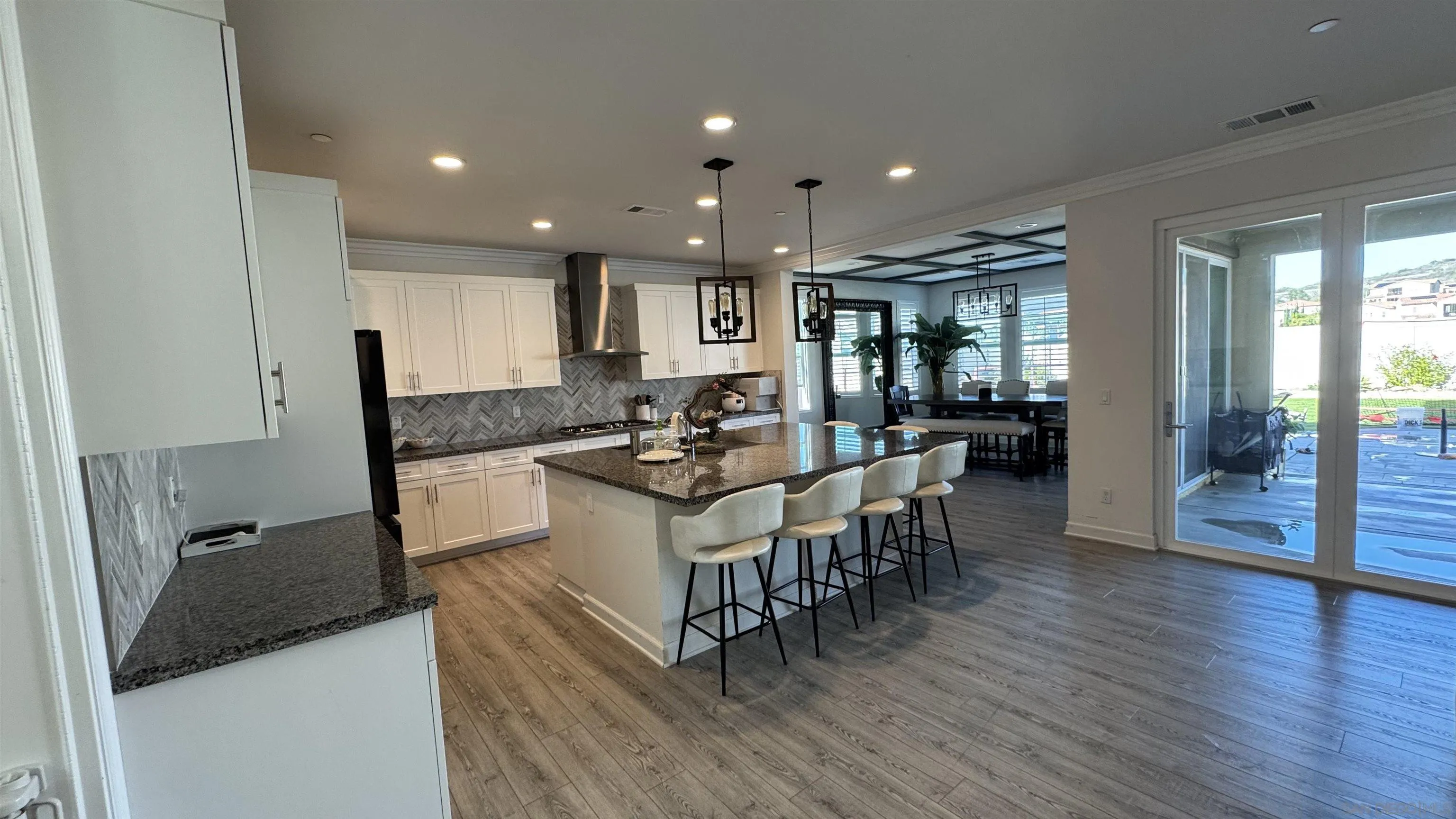 1337 Baumgartner Way Escondido, CA 92026 - Photo 14 of 20 a kitchen with granite countertop a stove a sink a dining table and chairs