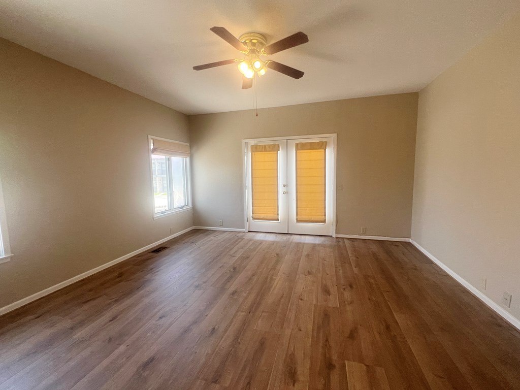 805-139 Highway 534 Loop Kerrville, TX 78028 - Photo 16 of 28 an empty room with wooden floor and windows