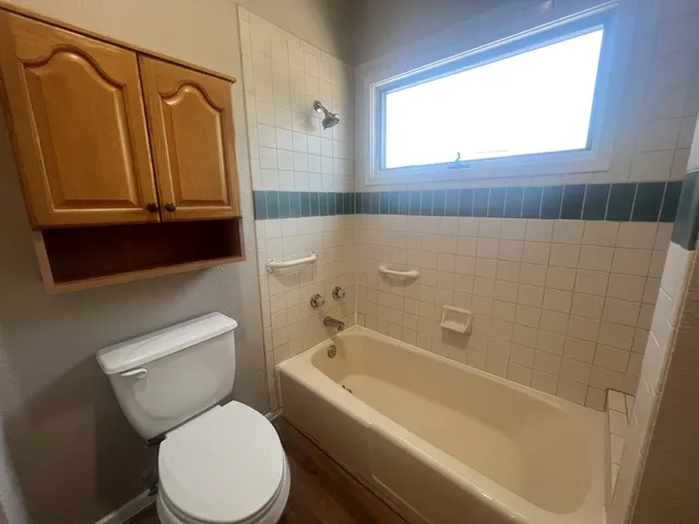 a bathroom with a toilet a sink and a bathtub