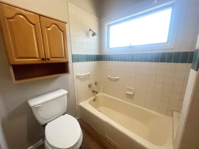 a bathroom with a toilet a sink and a bathtub