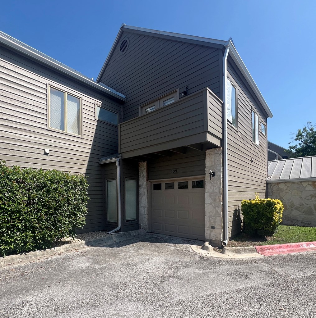 805-139 Highway 534 Loop Kerrville, TX 78028 - Photo 22 of 28 a front view of a house with a yard and garage