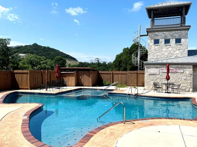 a view of a backyard with swimming pool