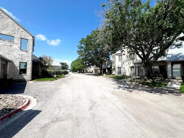 a view of road with card parked on side and road
