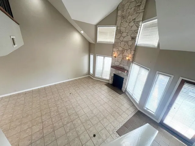 a view of an empty room and a fireplace