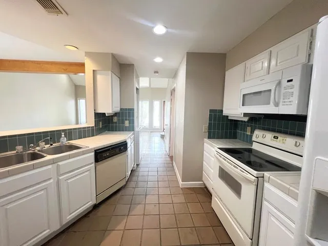a kitchen with a sink stove and cabinets