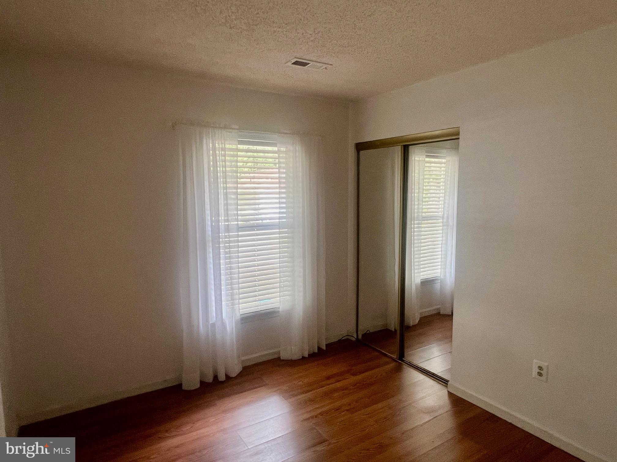60 Nottingham Lane Berlin, MD 21811 - Photo 16 of 38 an empty room with wooden floor and windows