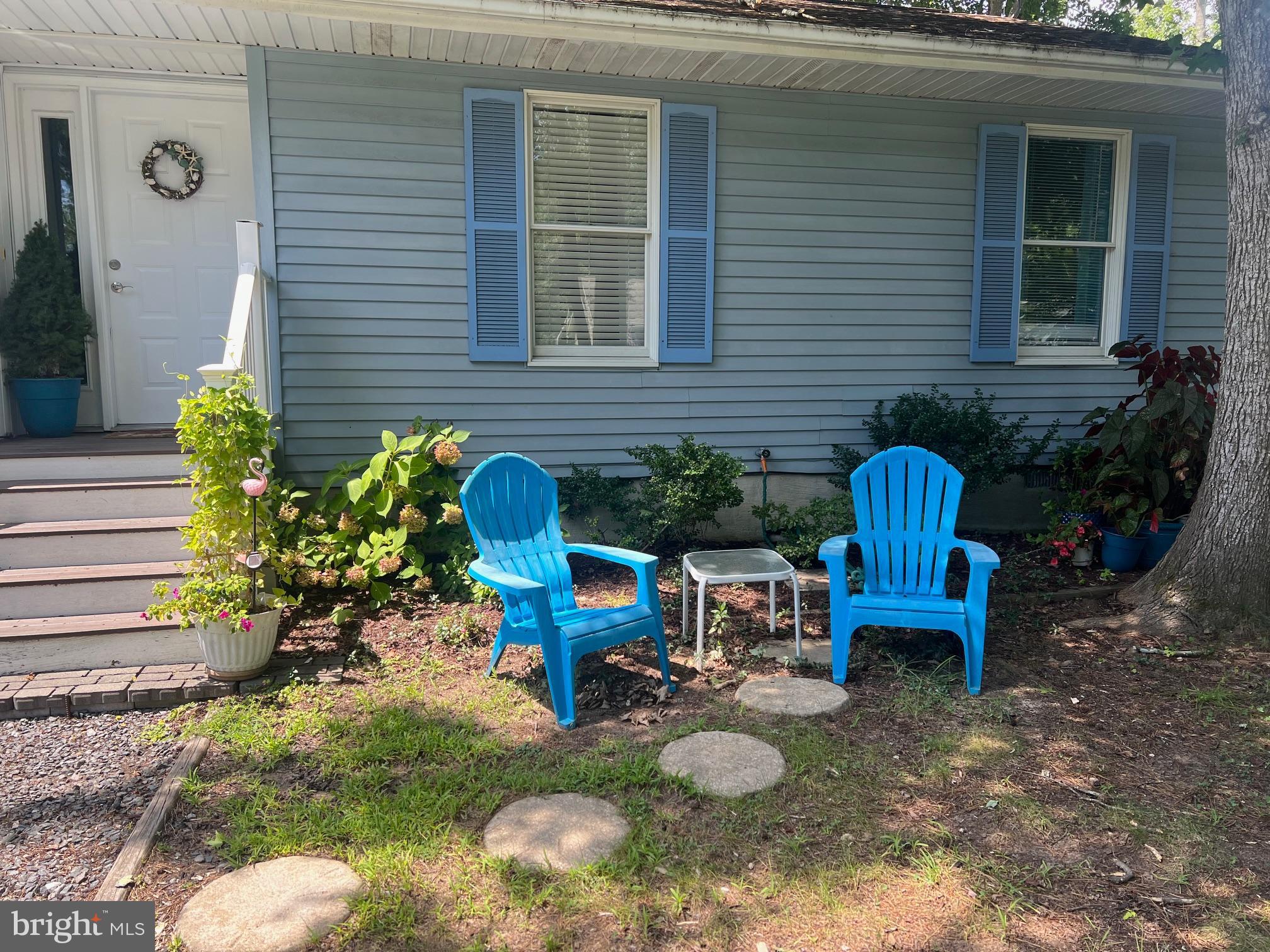 60 Nottingham Lane Berlin, MD 21811 - Photo 3 of 38 a view of a backyard with chairs and potted plants