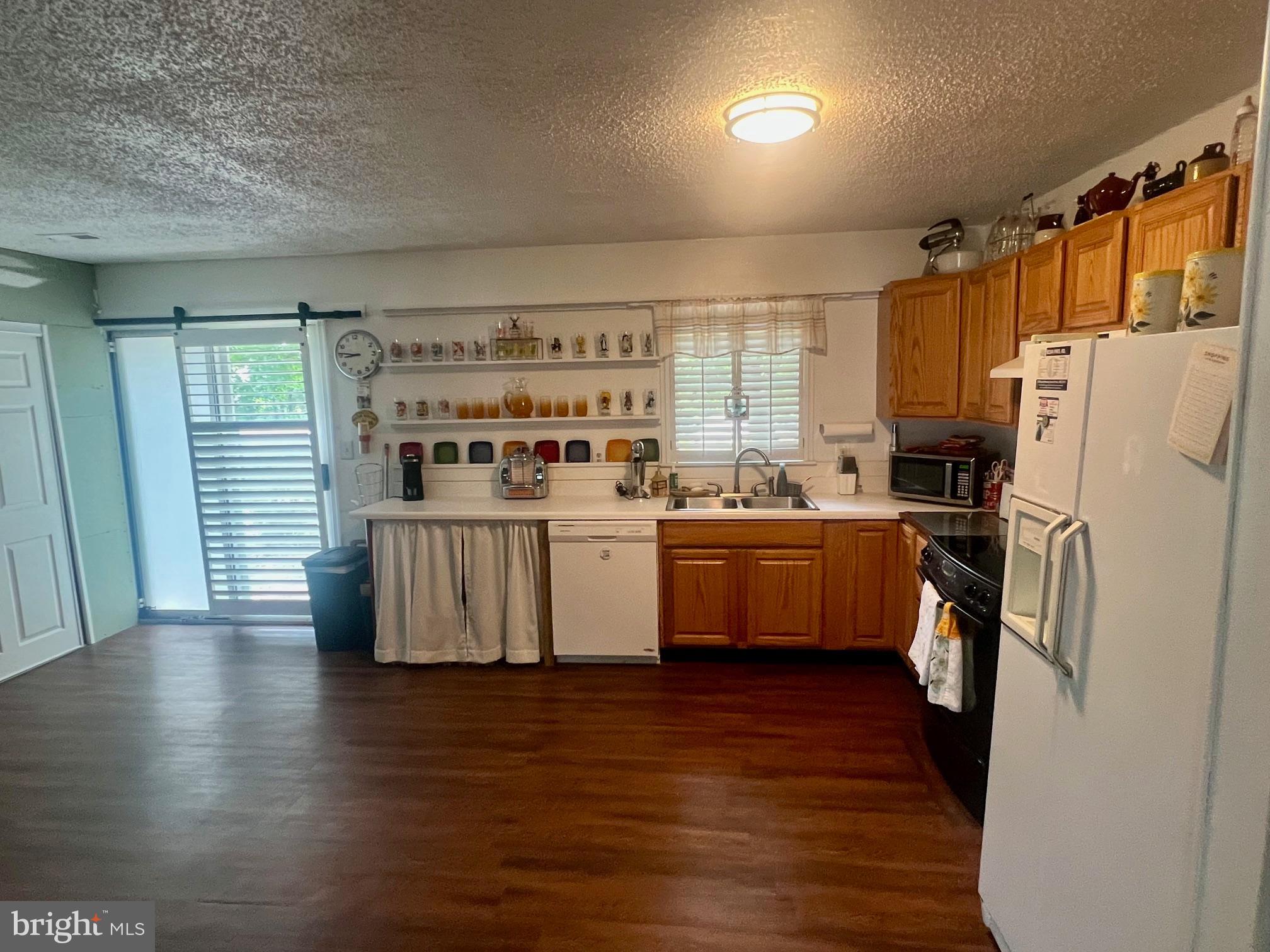 60 Nottingham Lane Berlin, MD 21811 - Photo 35 of 38 a kitchen with stainless steel appliances a refrigerator sink and cabinets
