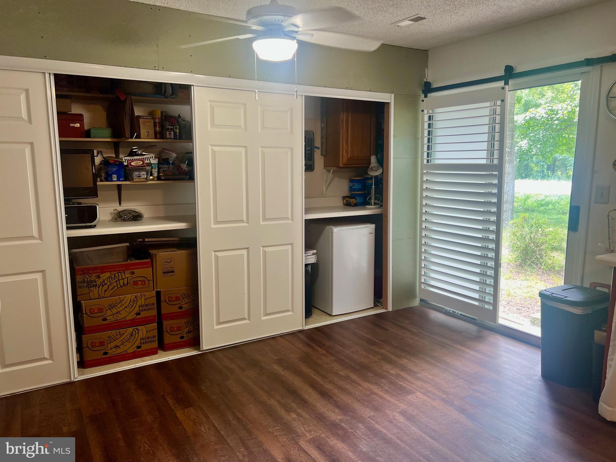 60 Nottingham Lane Berlin, MD 21811 - Photo 9 of 38 a view of a kitchen with fridge and wooden floor