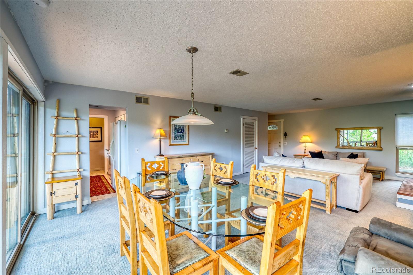 2510 Ryan Gulch Road, Unit 2512 Silverthorne, CO 80498 - Photo 11 of 41 a view of a dining room with furniture window and wooden floor