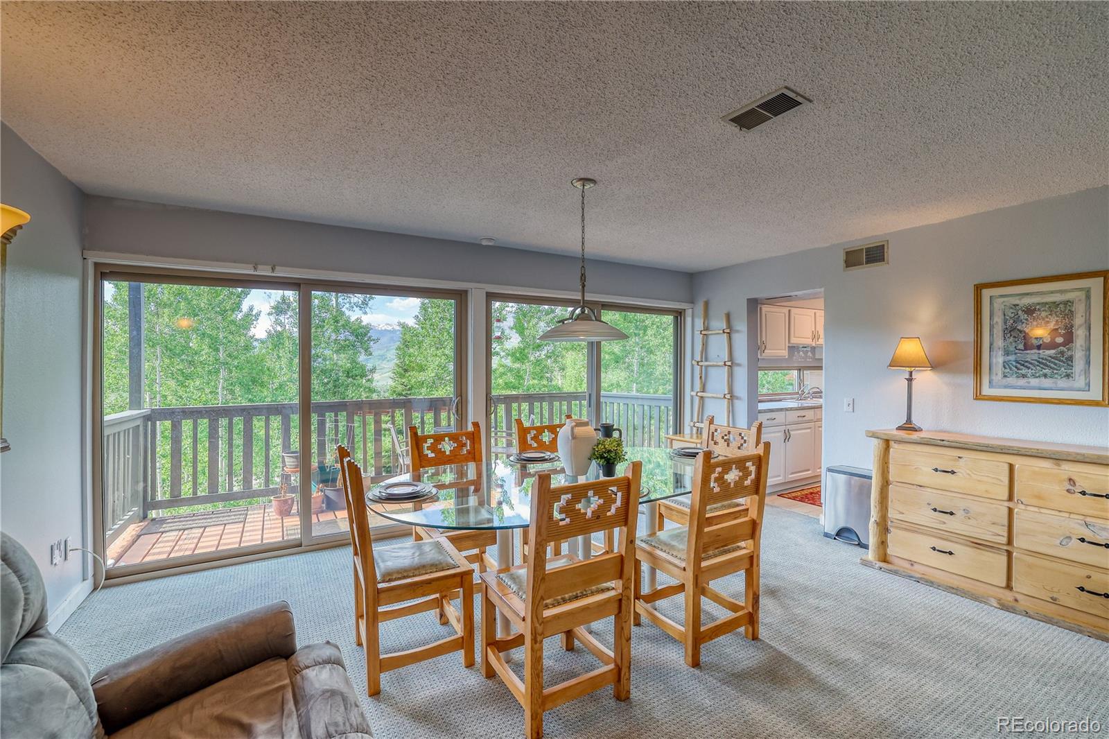 2510 Ryan Gulch Road, Unit 2512 Silverthorne, CO 80498 - Photo 12 of 41 a living room with furniture and large windows