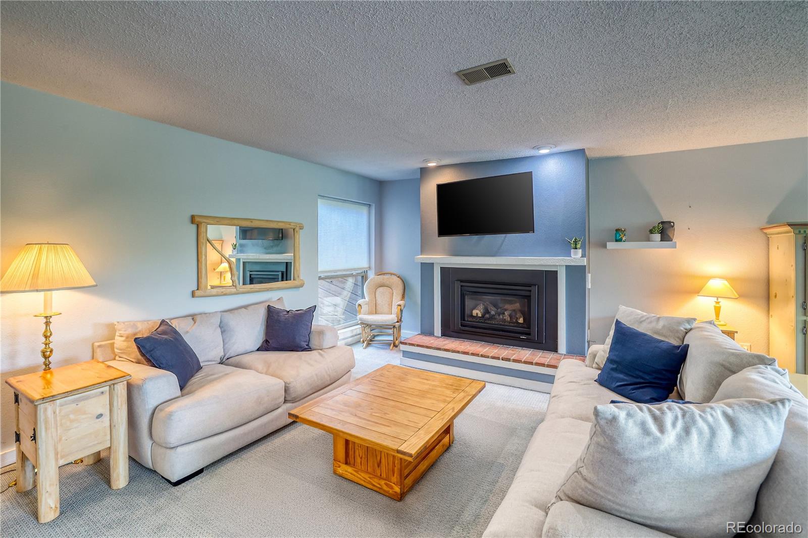 2510 Ryan Gulch Road, Unit 2512 Silverthorne, CO 80498 - Photo 14 of 41 a living room with furniture and a fireplace