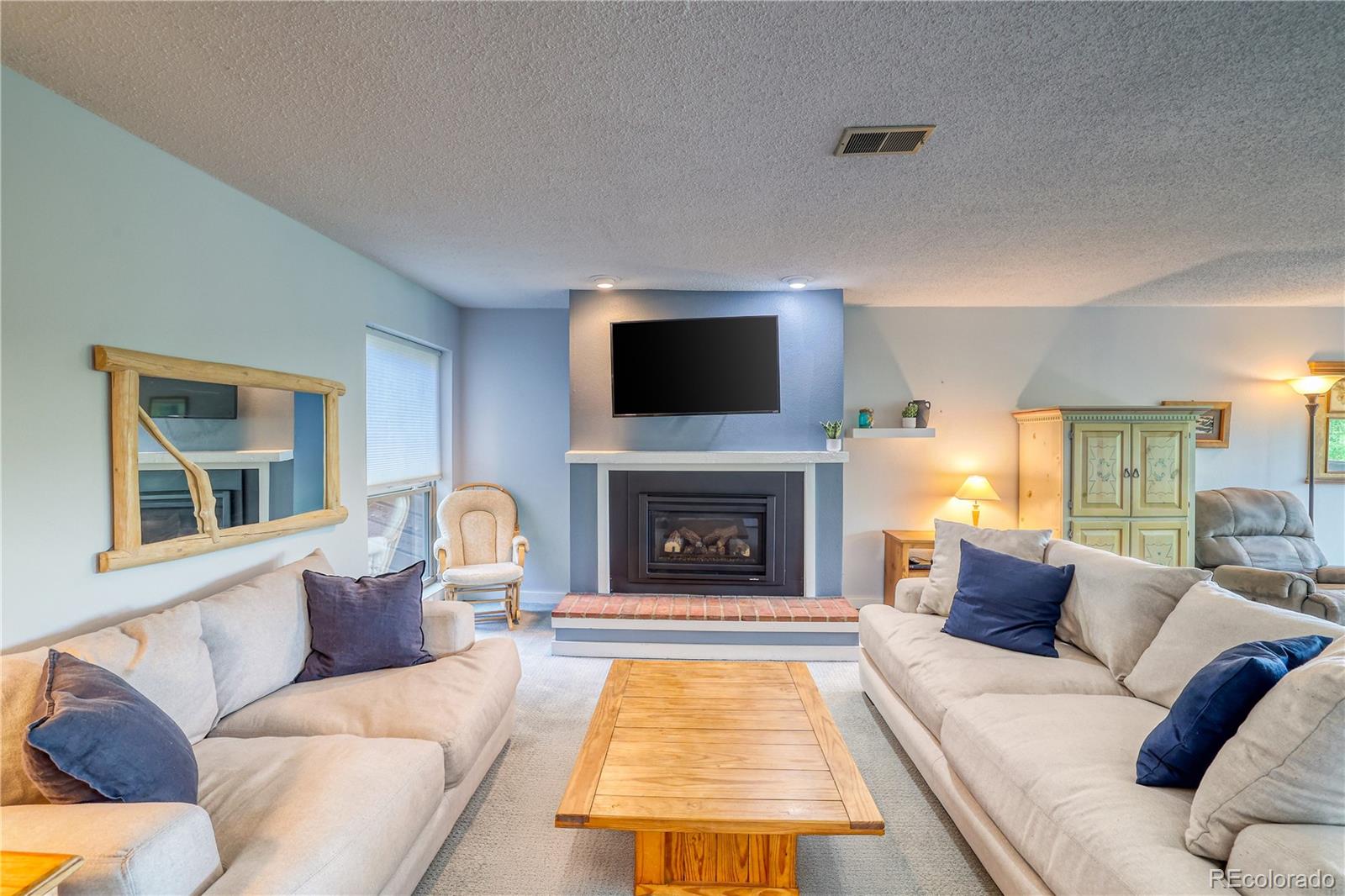 2510 Ryan Gulch Road, Unit 2512 Silverthorne, CO 80498 - Photo 15 of 41 a living room with furniture and a fireplace