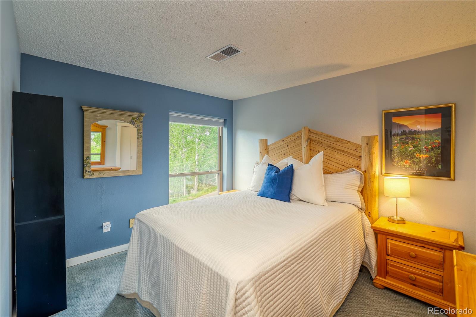 2510 Ryan Gulch Road, Unit 2512 Silverthorne, CO 80498 - Photo 19 of 41 a bedroom with a bed and wooden floor