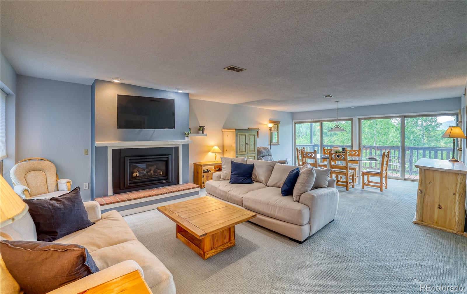 2510 Ryan Gulch Road, Unit 2512 Silverthorne, CO 80498 - Photo 2 of 41 a living room with furniture and a fireplace