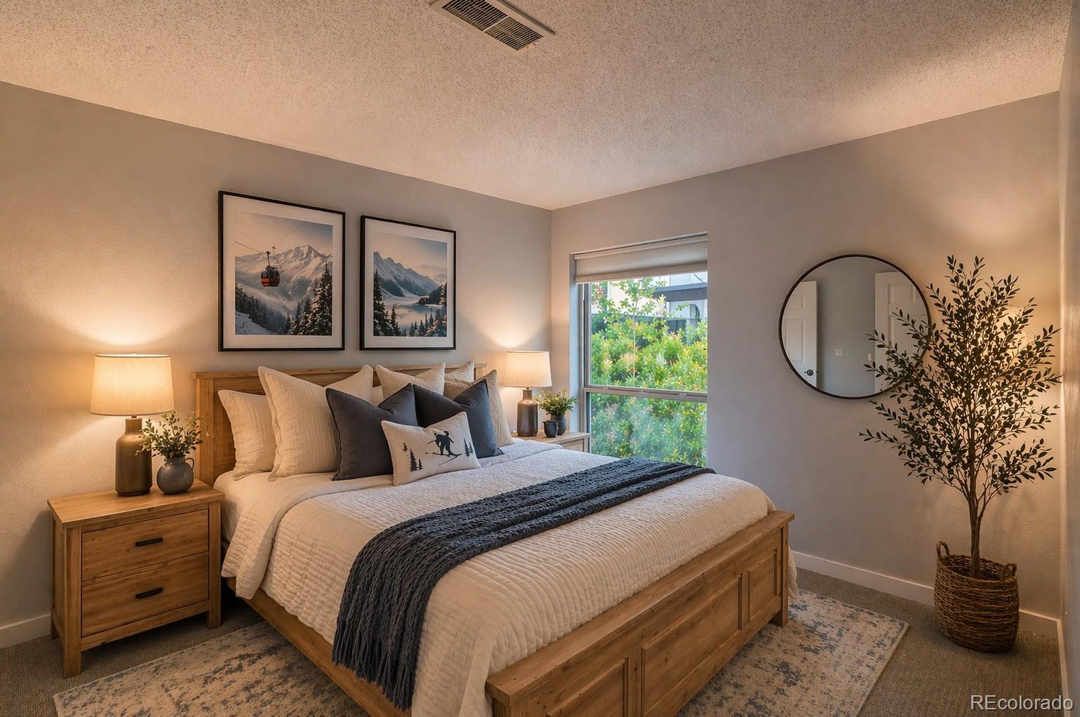 2510 Ryan Gulch Road, Unit 2512 Silverthorne, CO 80498 - Photo 28 of 41 a bedroom with a large bed and a potted plant