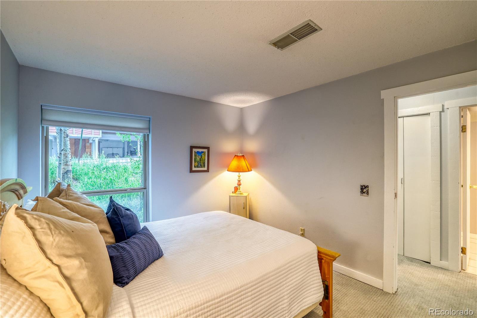 2510 Ryan Gulch Road, Unit 2512 Silverthorne, CO 80498 - Photo 29 of 41 a bedroom with a bed and a window