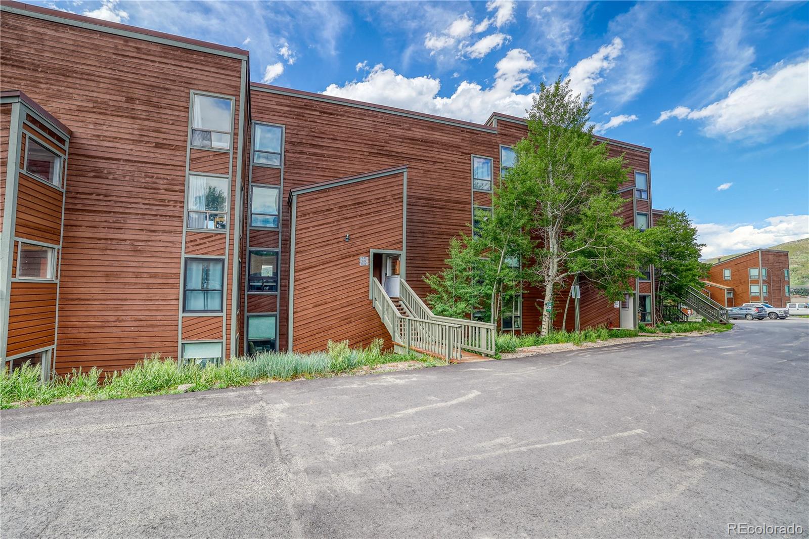 2510 Ryan Gulch Road, Unit 2512 Silverthorne, CO 80498 - Photo 31 of 41 a view of a brick house with a yard and large tree