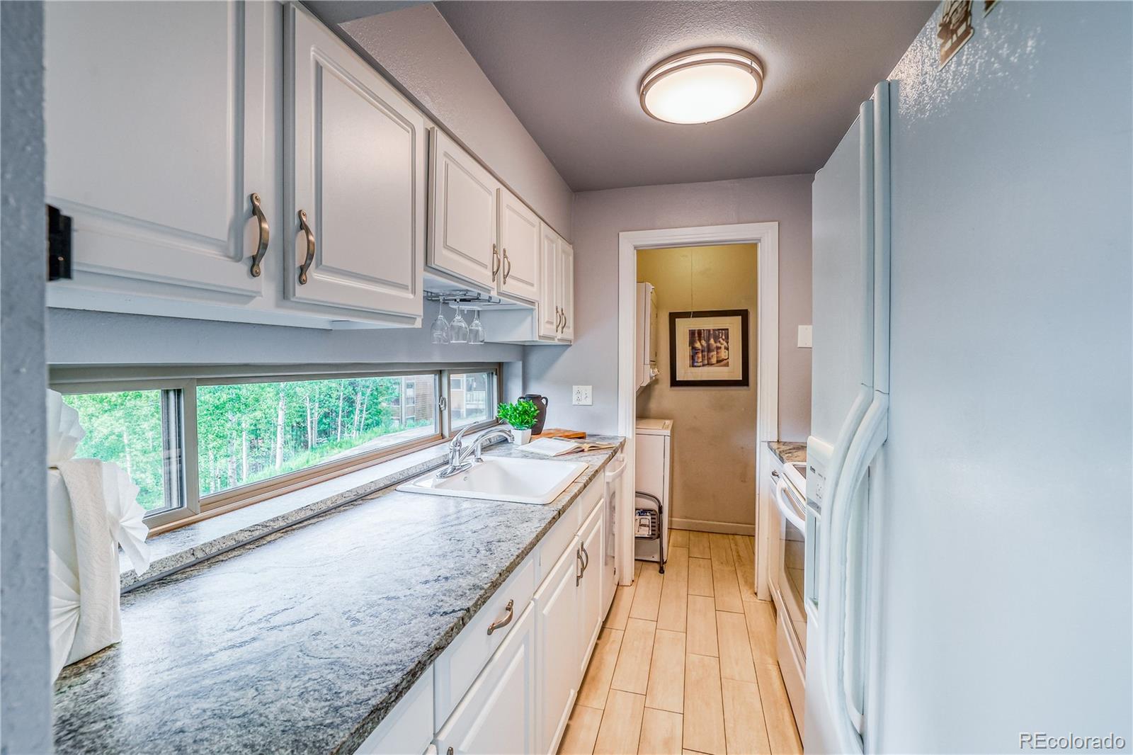 2510 Ryan Gulch Road, Unit 2512 Silverthorne, CO 80498 - Photo 6 of 41 a view of a kitchen with a large window