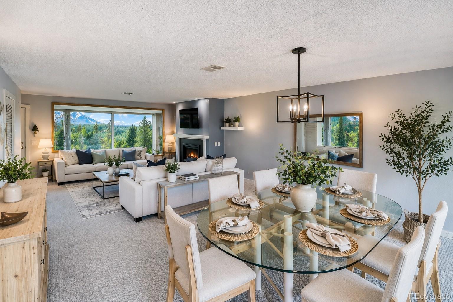 2510 Ryan Gulch Road, Unit 2512 Silverthorne, CO 80498 - Photo 9 of 41 a view of a dining room and livingroom with furniture wooden floor a chandelier
