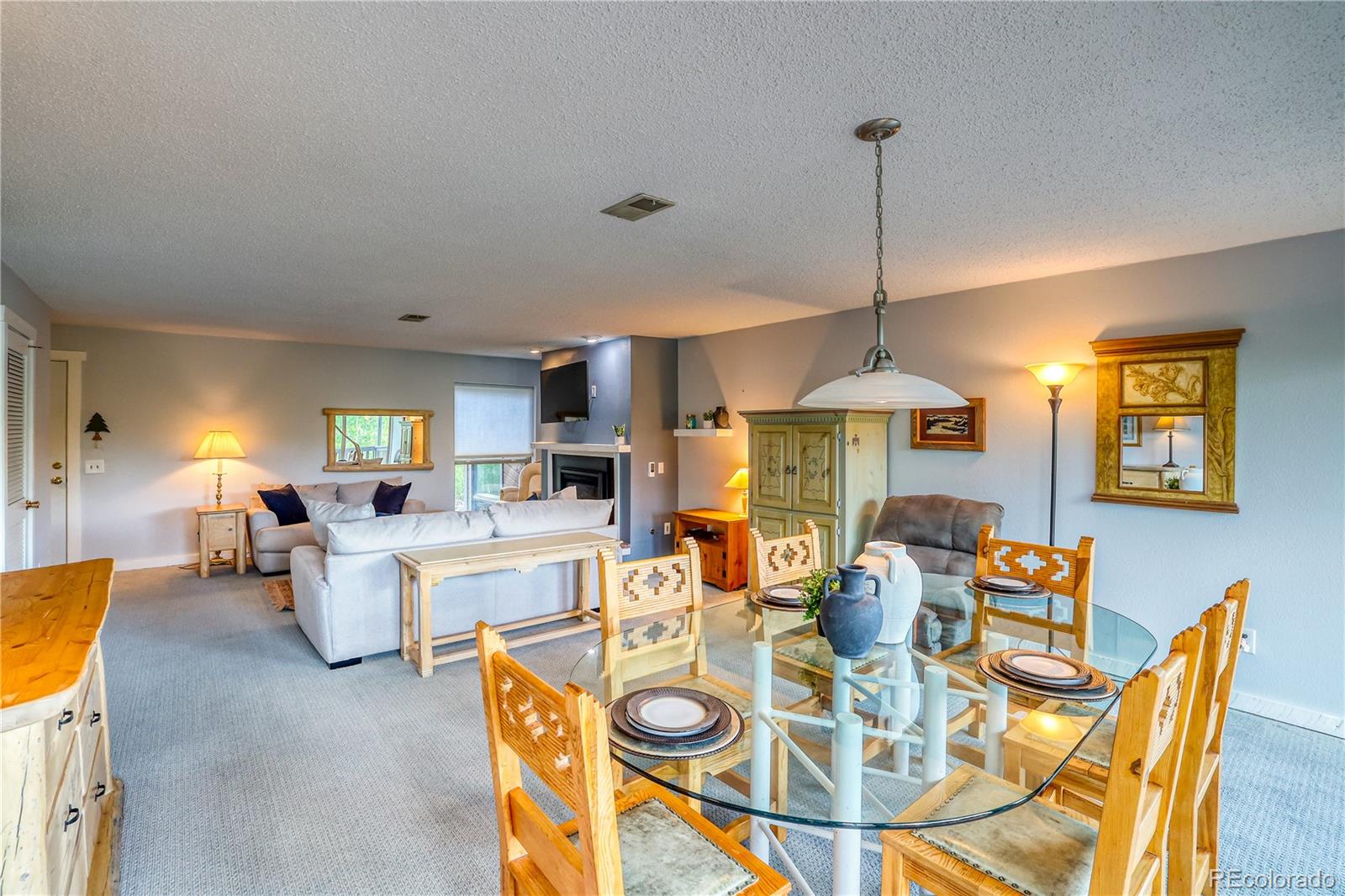2510 Ryan Gulch Road, Unit 2512 Silverthorne, CO 80498 - Photo 10 of 41 a living room with furniture a dining table and a chandelier