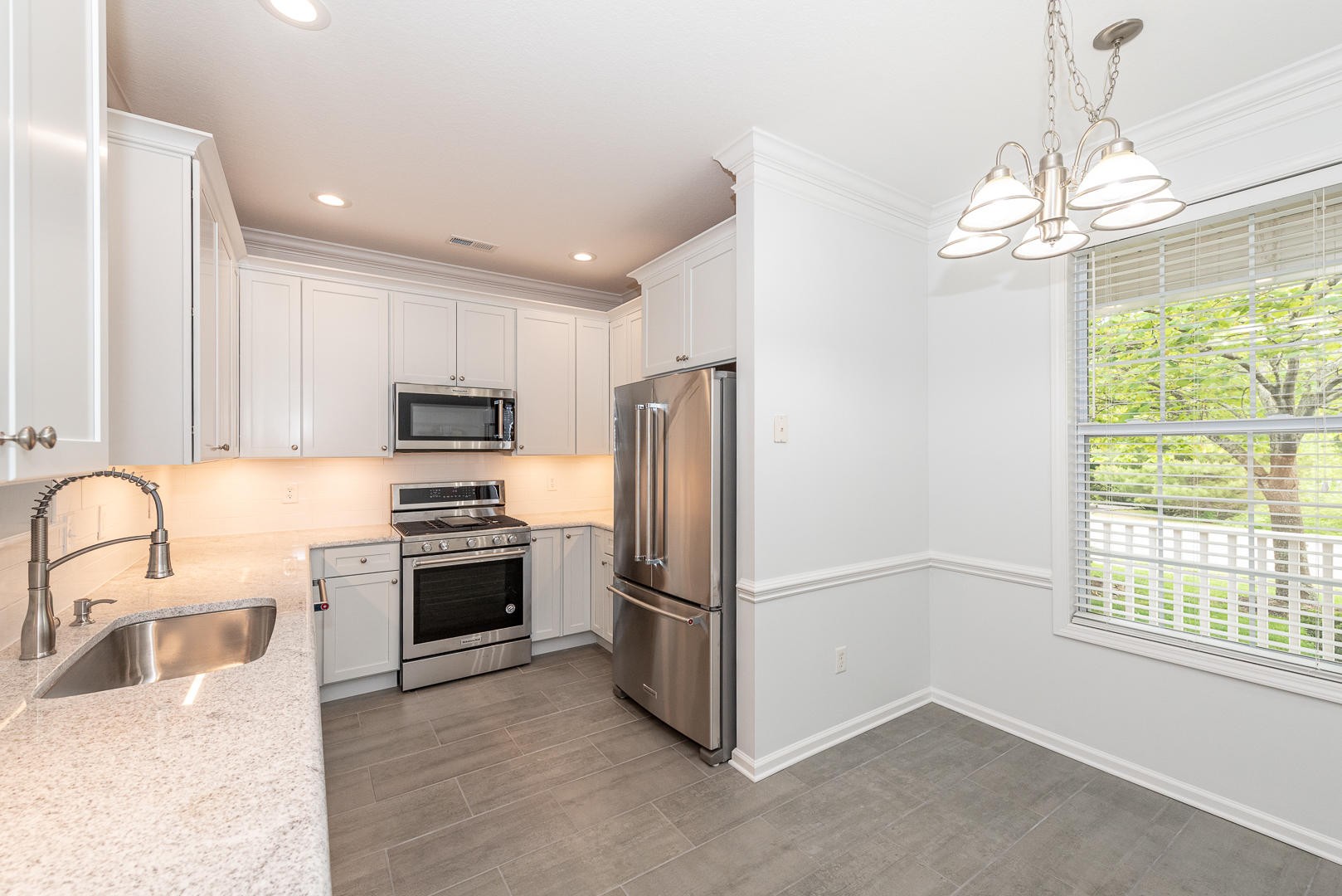 116 Devanshire Court Oak Ridge, TN 37830 - Photo 6 of 30 a kitchen with stainless steel appliances granite countertop a refrigerator a stove a sink and a dining table with wooden floor