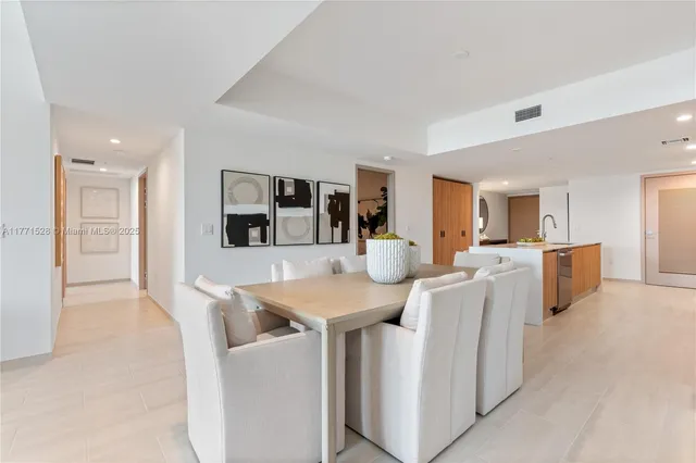 a large kitchen with a lot of counter space and wooden floor
