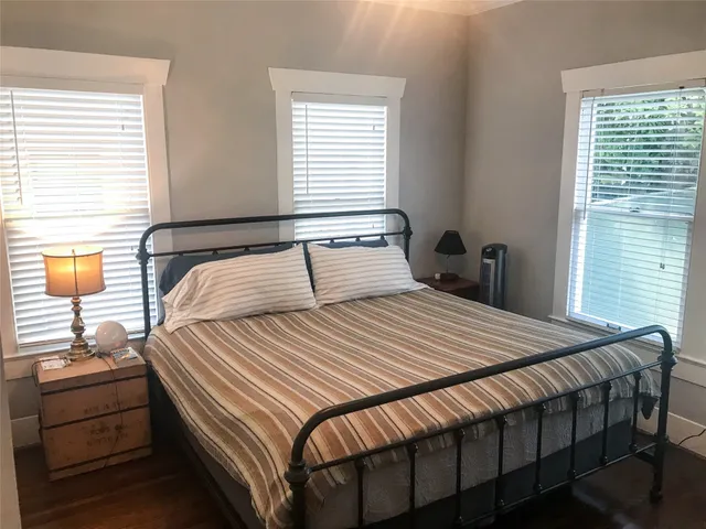 a bedroom with a bed and window